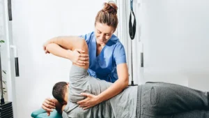 Chiropractor performing a spinal adjustment on a patient